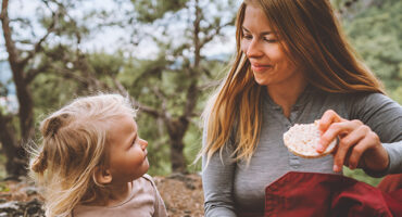 mother and daughter child outdoor in forest on picnic