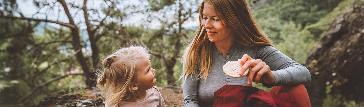 mother and daughter child outdoor in forest on picnic